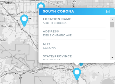 Screenshot of a grayscale map with blue pins. Above one of the pins is a pop-out bubble listing pertinent location information pulled directly from a dataset.