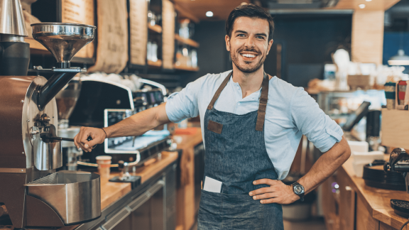 A coffee barista at Scooter's Coffee is happy now that fulfillment mistakes have been eliminated with Geo Analytics